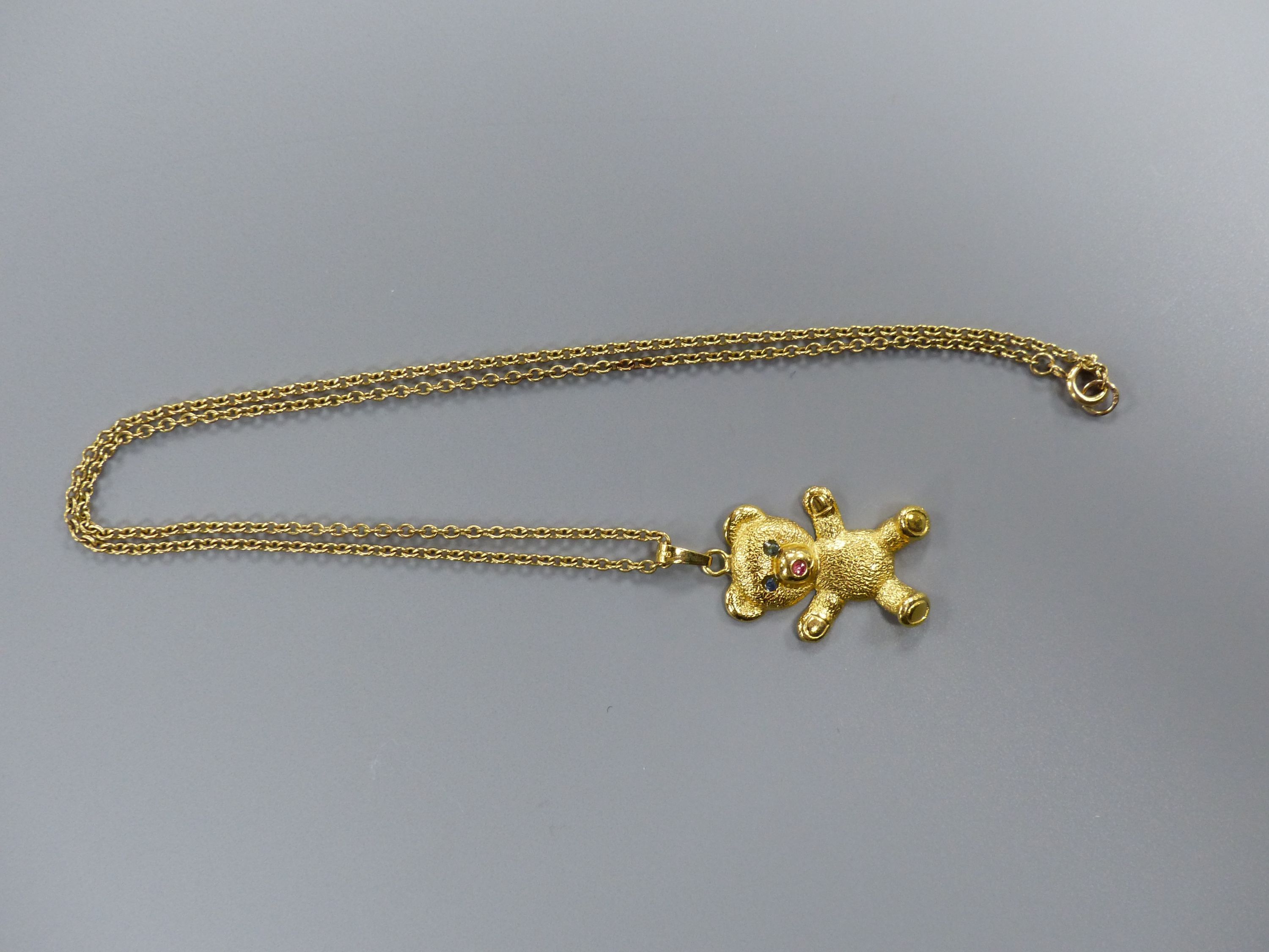 A modern 9ct gold and gem set teddy bear pendant, 26mm, on a 9ct chain, 41cm,